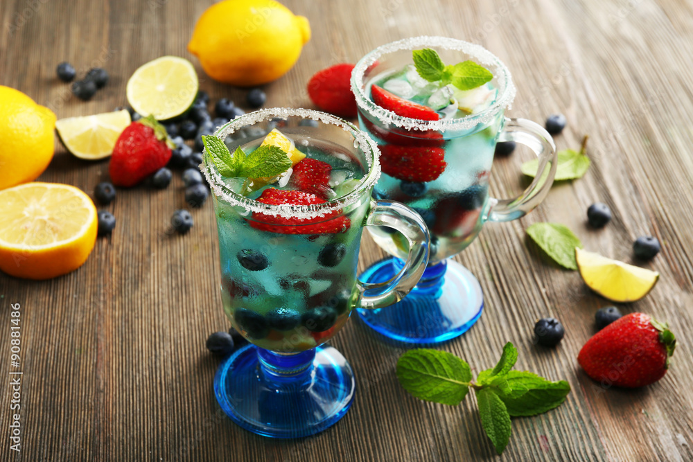 Glasses of berries juice on wooden background Glasses of berries juice on wooden background
