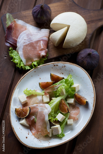 Salad with ham, cheese and fig fruits, top view, studio shot