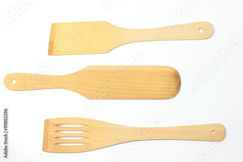 Wooden spoons, spatulas and a fork isolated on white background