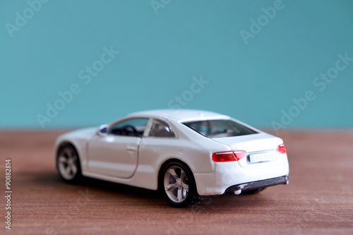 Small toy car on blue background © Africa Studio