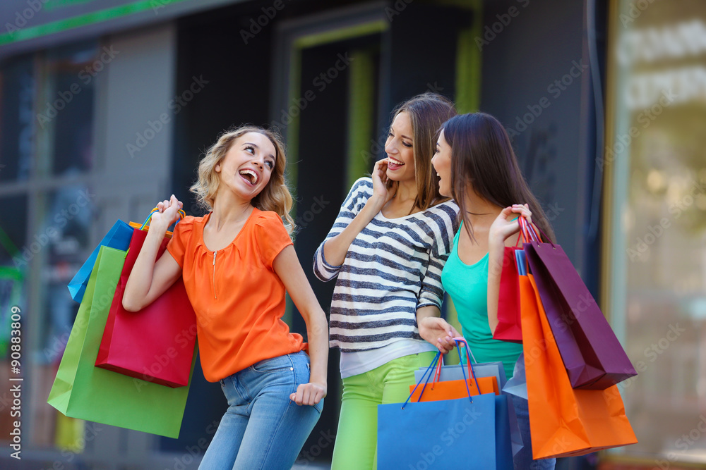 Beautiful young women with shopping bags on city street Beautiful young women with shopping bags on city street