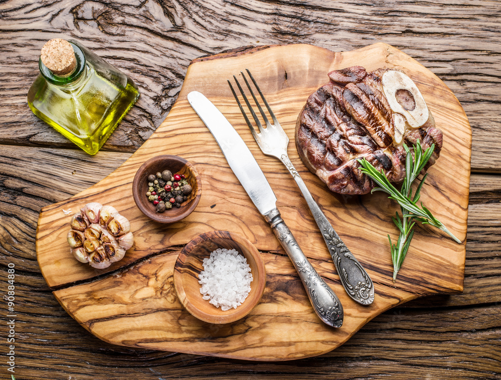 Beef steaks with spices on a wooden tray. Beef steaks with spices on a wooden tray.