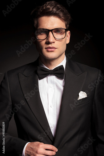 young elegant man closing his jacket