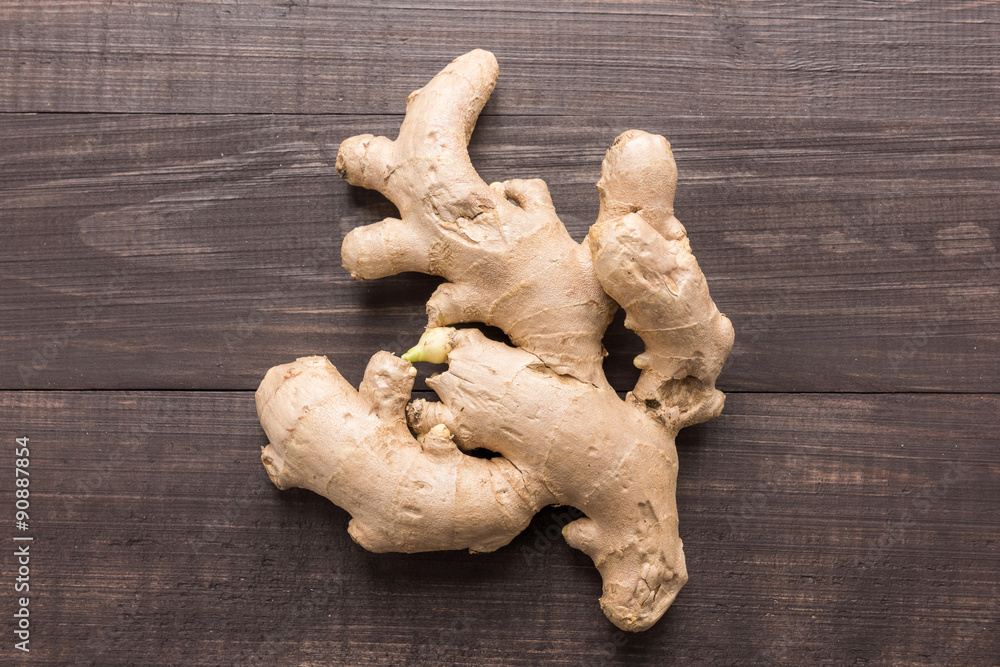 Ginger root on the wooden background. Top view Ginger root on the wooden background. Top view