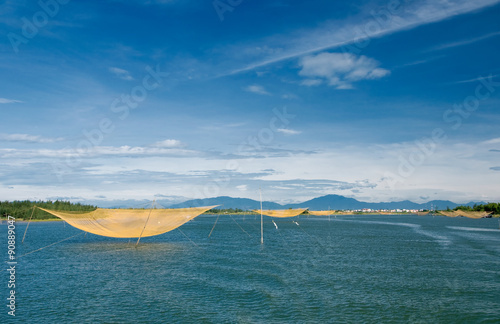 Fish net on Hoai river at Hoi An, Danang, Vietnam.  Hội An is recognized as a World Heritage Site by UNESCO. photo