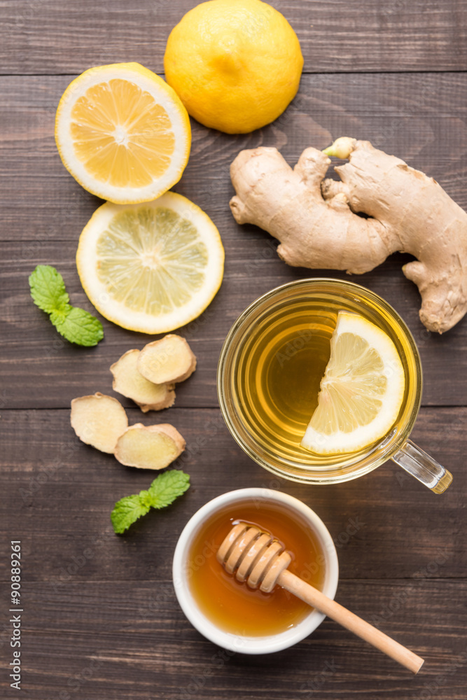 Cup of ginger tea with lemon and honey on wooden background Cup of ginger tea with lemon and honey on wooden background