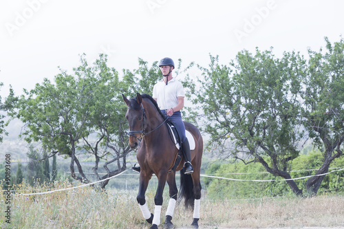 boy riding a horse.