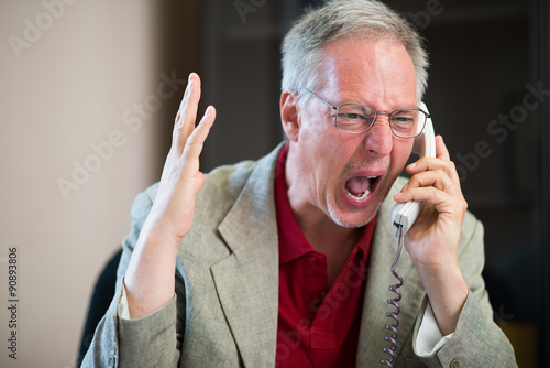 Angry man yelling on the phone