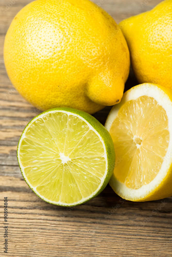 Fresh and juicy lemons and lime on a wooden surface Fresh and juicy lemons and lime on a wooden surface