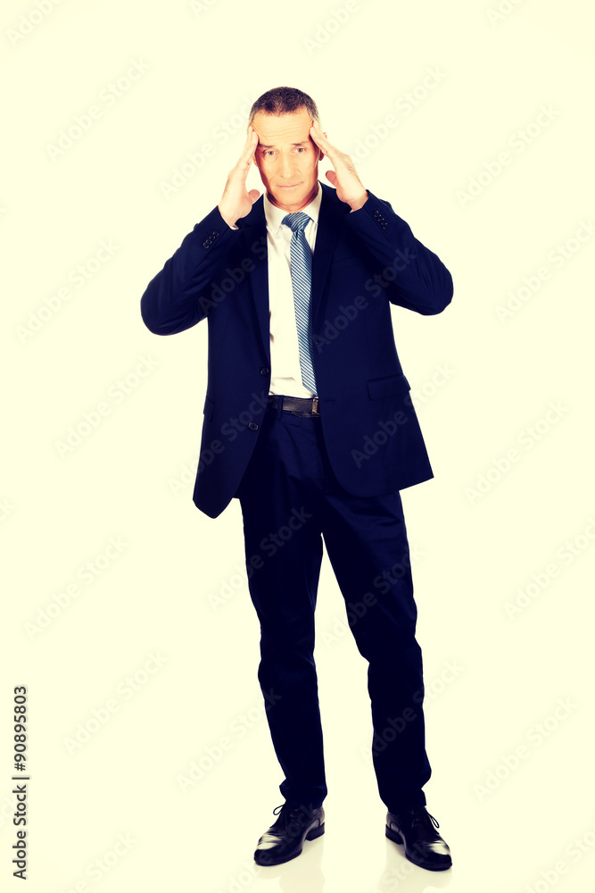 Full length businessman suffering from headache Full length businessman suffering from headache