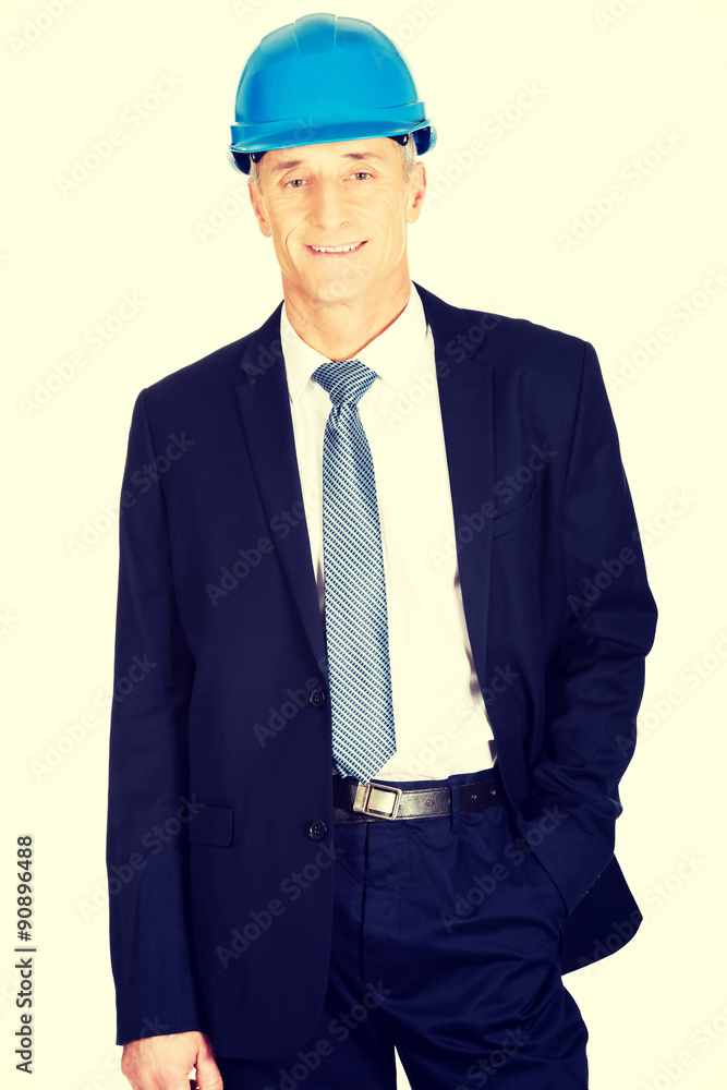 Businessman with hand in pocket wearing a helmet Businessman with hand in pocket wearing a helmet
