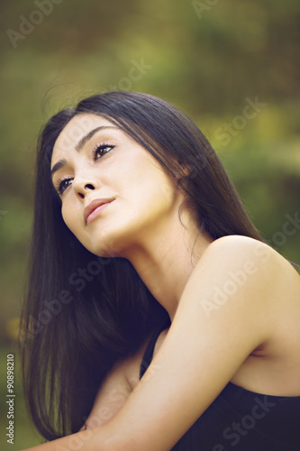 Portrait close up of young beautiful woman, on green background