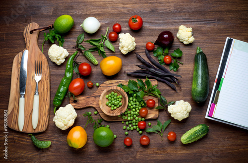 Fototapeta Naklejka Na Ścianę i Meble -  Healthy food. Herbs and vegetables on wooden table with recipe