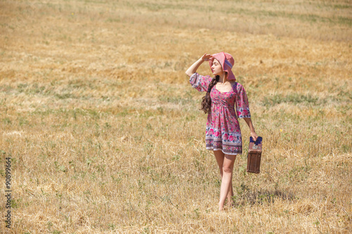 girl in hat on wheat field © producer