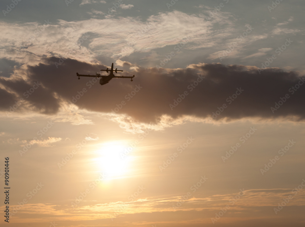 Silhouette of an airplane at sunset.