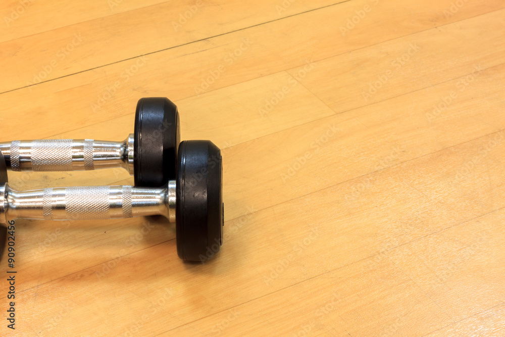 Fototapeta premium Dumbbells on the wood background.