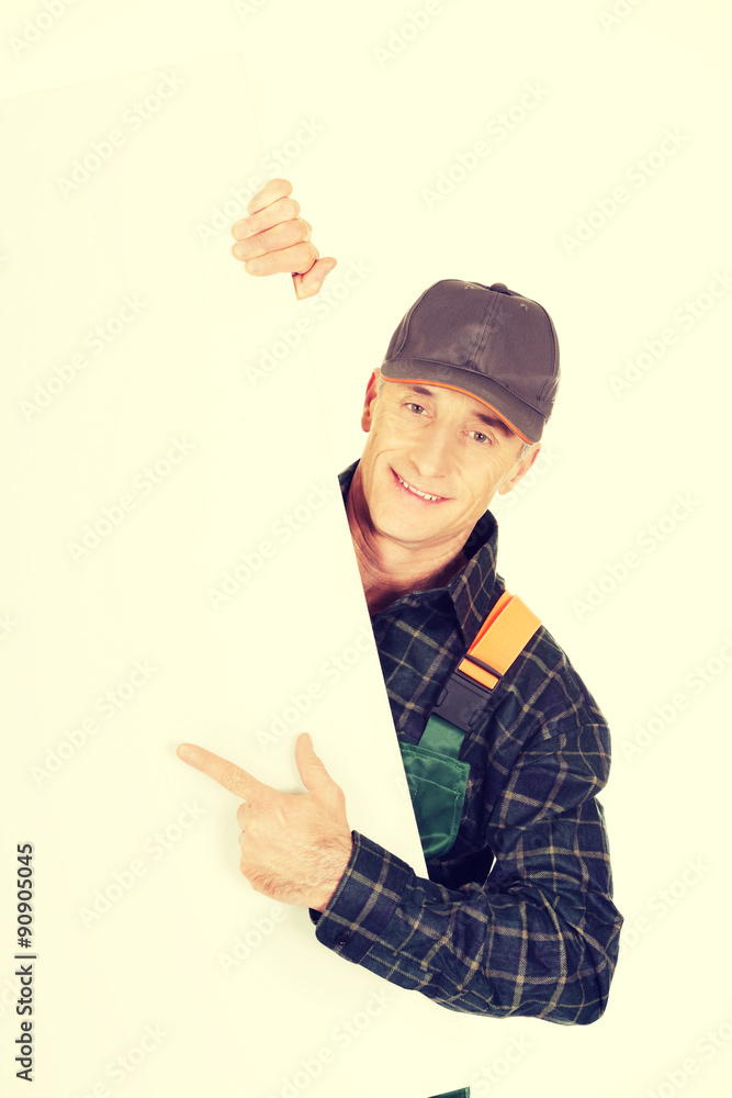 Gardener in uniform showing empty banner Gardener in uniform showing empty banner