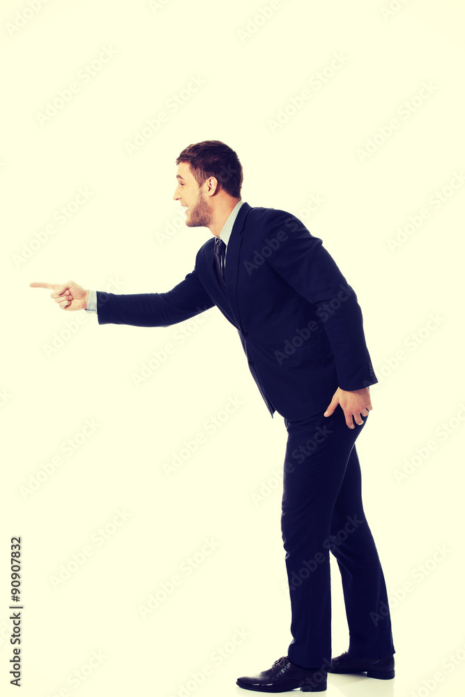 Angry businessman pointing to the left. Angry businessman pointing to the left.