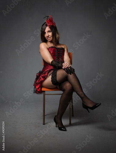 burlesque woman sitting with crossing legs
