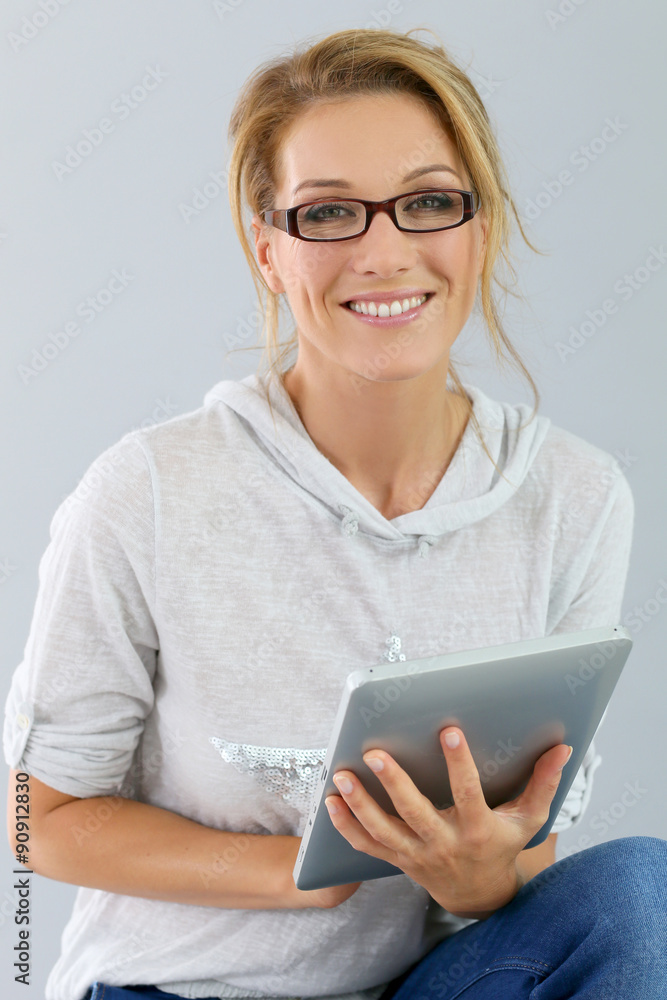 Fototapeta premium Smiling woman using digital tablet, isolated