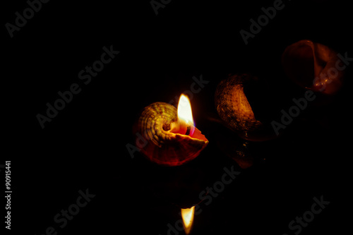 Candle on dark background.