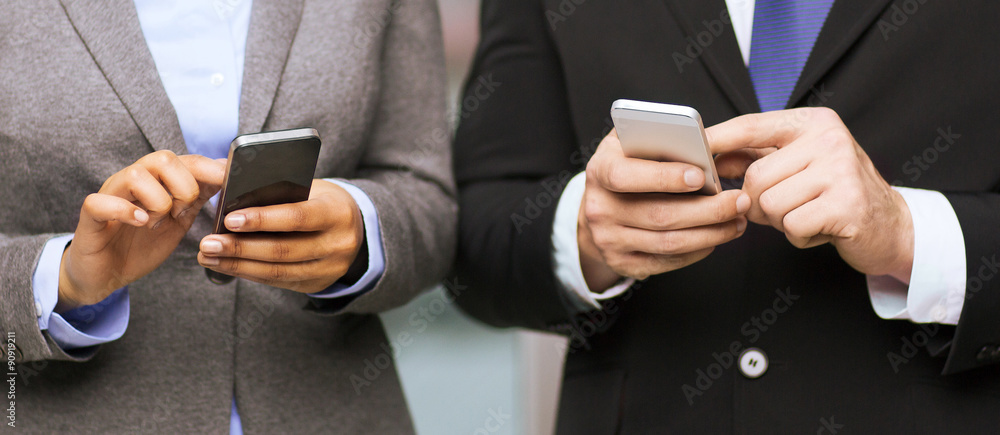 businessman and businesswoman with smartphones businessman and businesswoman with smartphones