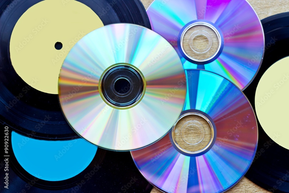 Vinyl record discs ans CD background Vinyl record discs ans CD background
