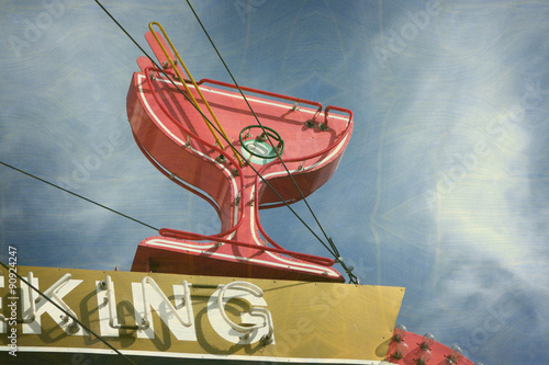 aged and worn vintage photo of neon martini glass sign