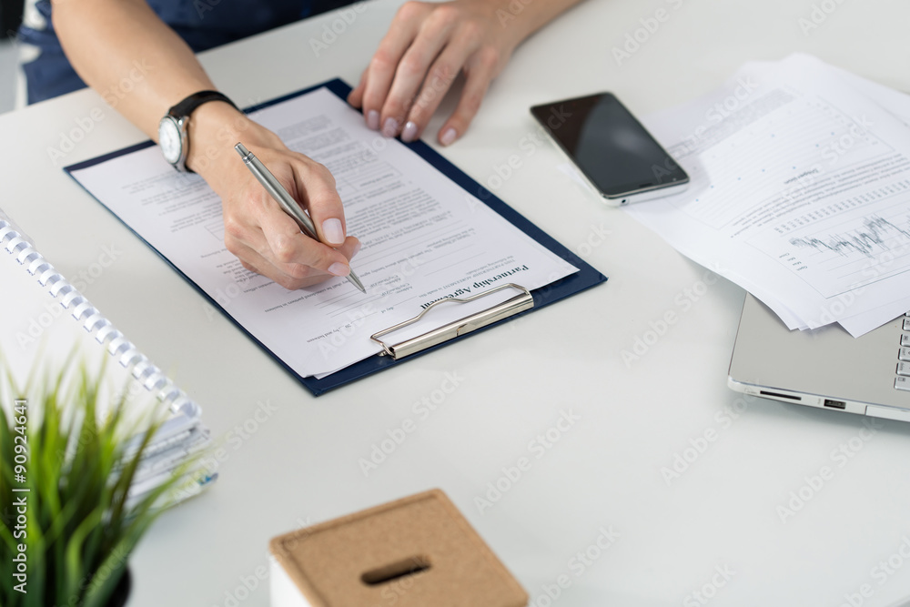 Business woman filling partnership agreement blank Business woman filling partnership agreement blank