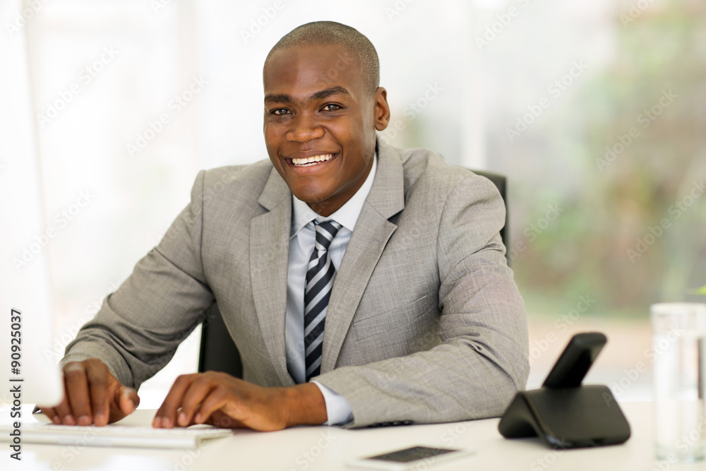 afro american businessman using computer in office afro american businessman using computer in office