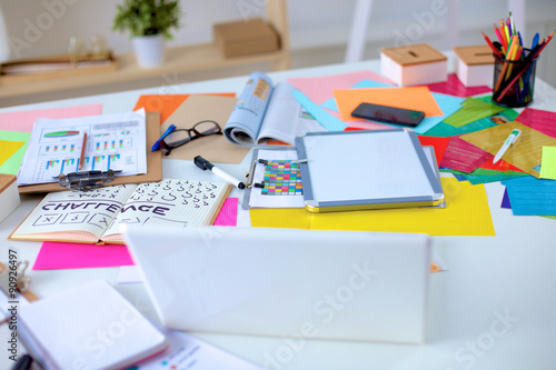 Desk of an artist with lots of stationery objects. Studio shot