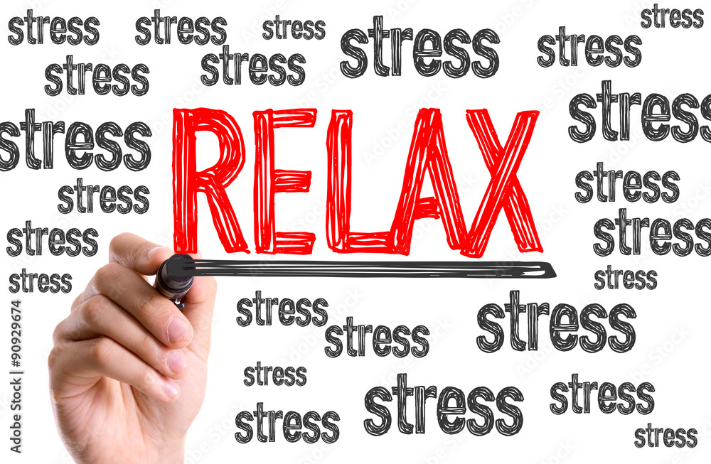 Hand with marker writing the word Relax Hand with marker writing the word Relax
