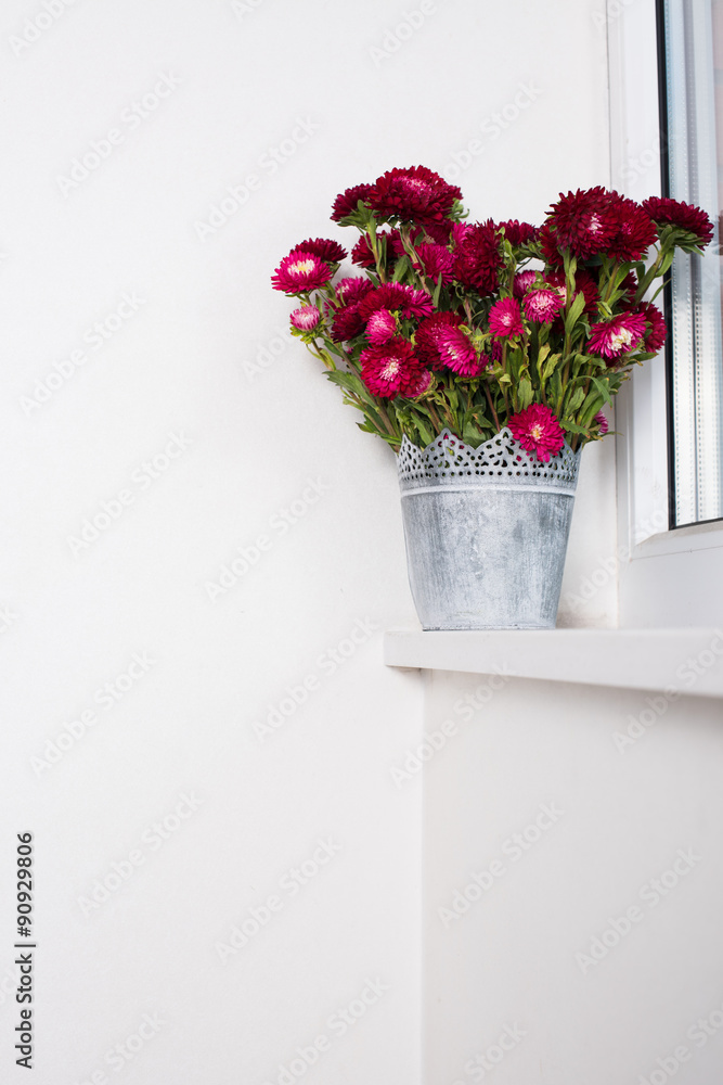 Red flowers in metal vase Red flowers in metal vase