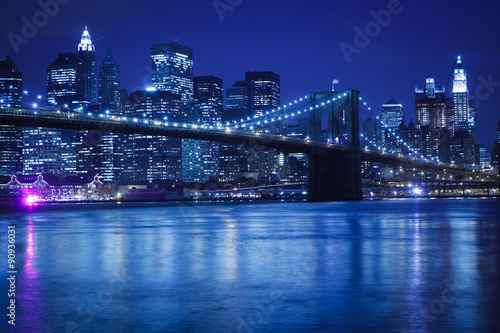 The Brooklyn Bridge against the Manhattan skyline in the early evening.