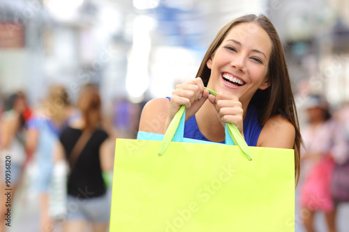 Shopper girl buying and holding a shopping bag