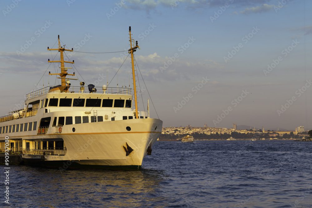 Passenger ship parked on Karakoy pier golden hour times near Golden Horn in Istanbul