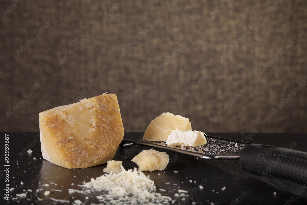 grated cheese, grated parmesan cheese with a grater and a jar and