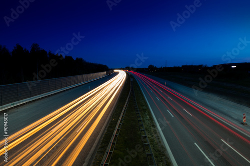 Light trails from car on highway