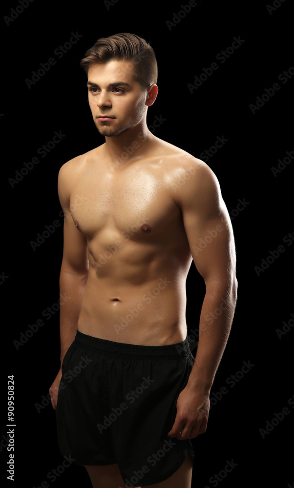Muscle young man on dark background Muscle young man on dark background