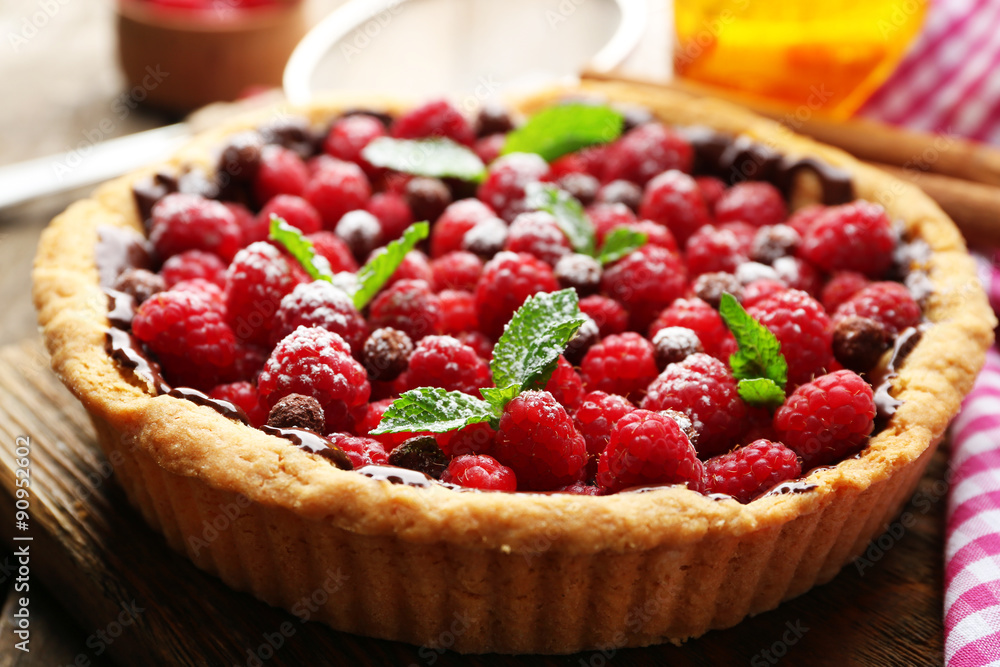 Tart with fresh raspberries, on wooden background Tart with fresh raspberries, on wooden background