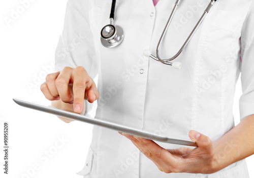 Female doctor working on digital tablet isolated on white