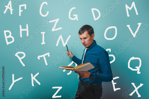 man Male teacher holding a book shows alphabet letter on infogra photo