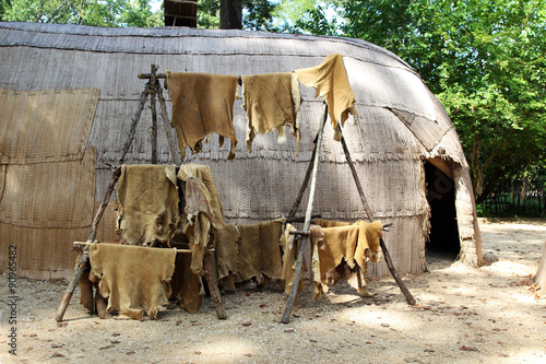 Animal skins drying at a replica of a native American house