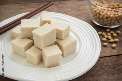 Tofu cubes on plate and soy beans in bowl