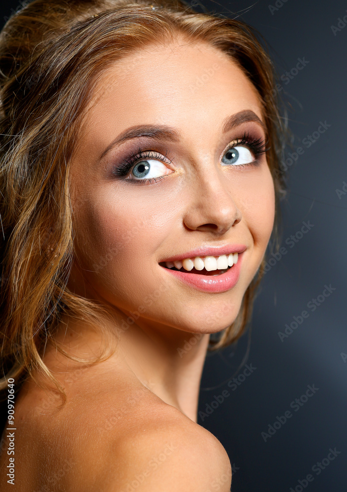 Beautiful woman with curly long hair on dark background Beautiful woman with curly long hair on dark background