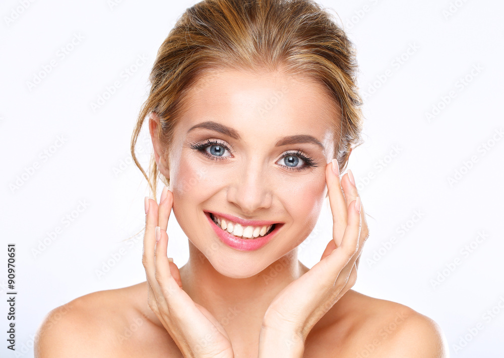 Young woman touching her face isolated on white background Young woman touching her face isolated on white background