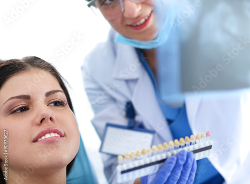 Fototapeta Naklejka Na Ścianę i Meble -  Woman dentist working at her patients teeth