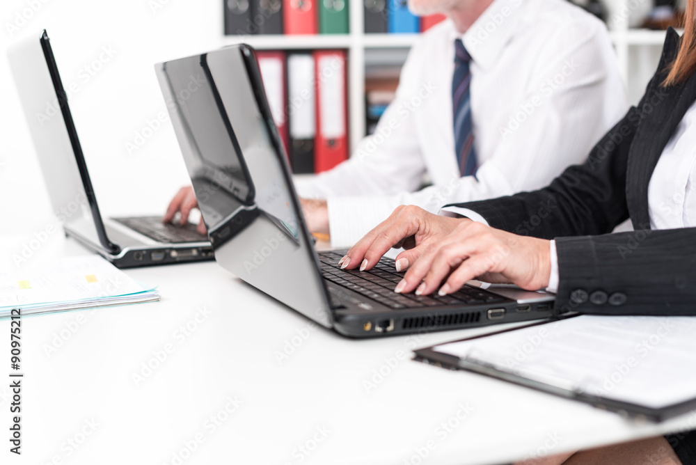 Businesspeople working on a laptop Businesspeople working on a laptop