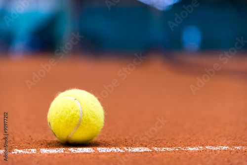 tennis ball on a clay court © meanmachine77