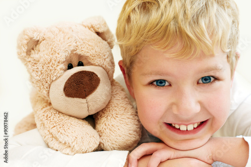 Joyful little boy with teddy bear is happy and smiling. Close-Up